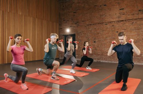 Indoor group workout session with dumbbells focusing on strength and fitness.